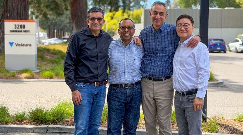Four Velaura representatives standing outside the Santa Clara office by a Velaura sign
