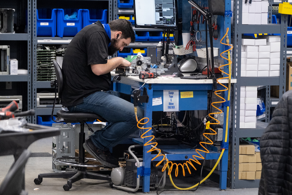 A technician working on equipment at Velocity’s repair depot
