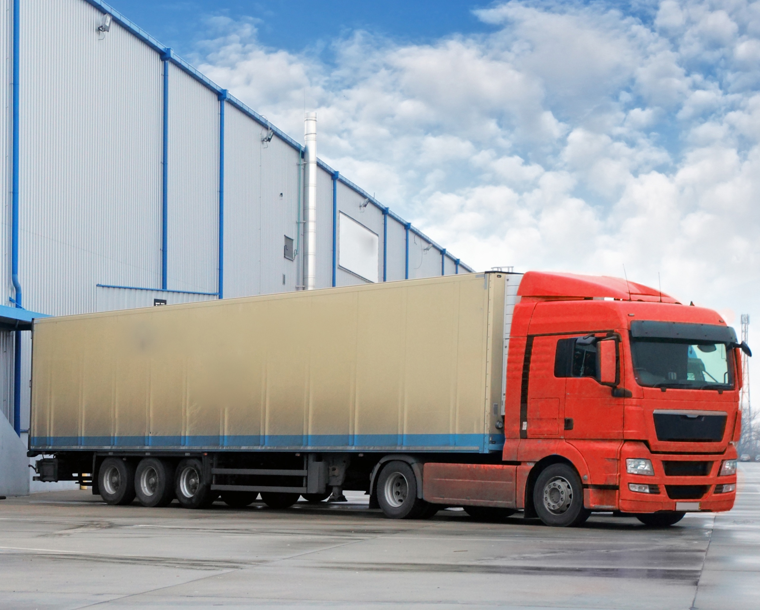 A red freight truck outside a warehouse, an illustrative logistics photograph from Velocity’s Knape and Vogt case study