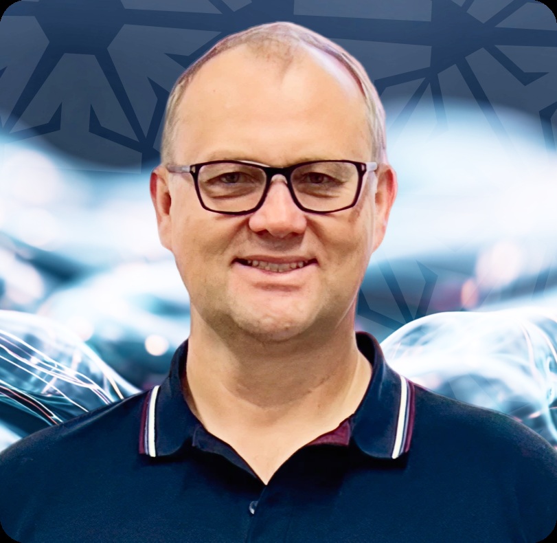 Velvetech founder and CEO Yuri Yushkov wearing glasses and a navy polo