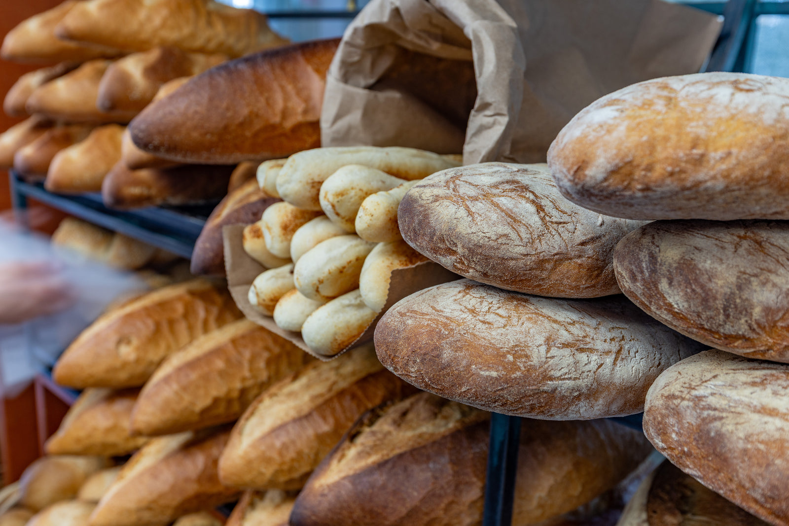 Bread and breadsticks piled on shelves at Venda Ravioli