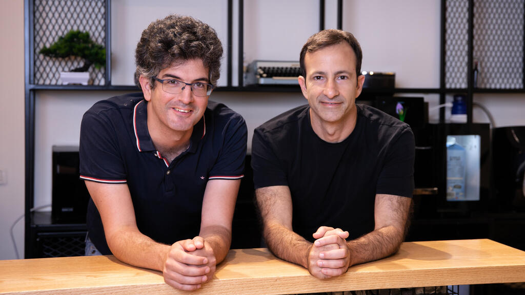Vendict co-founders Michael Keslassy and Udi Cohen seated at a table
