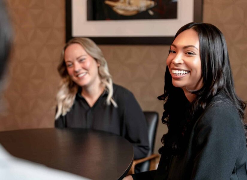 Two Venn Strategies colleagues smiling during a meeting