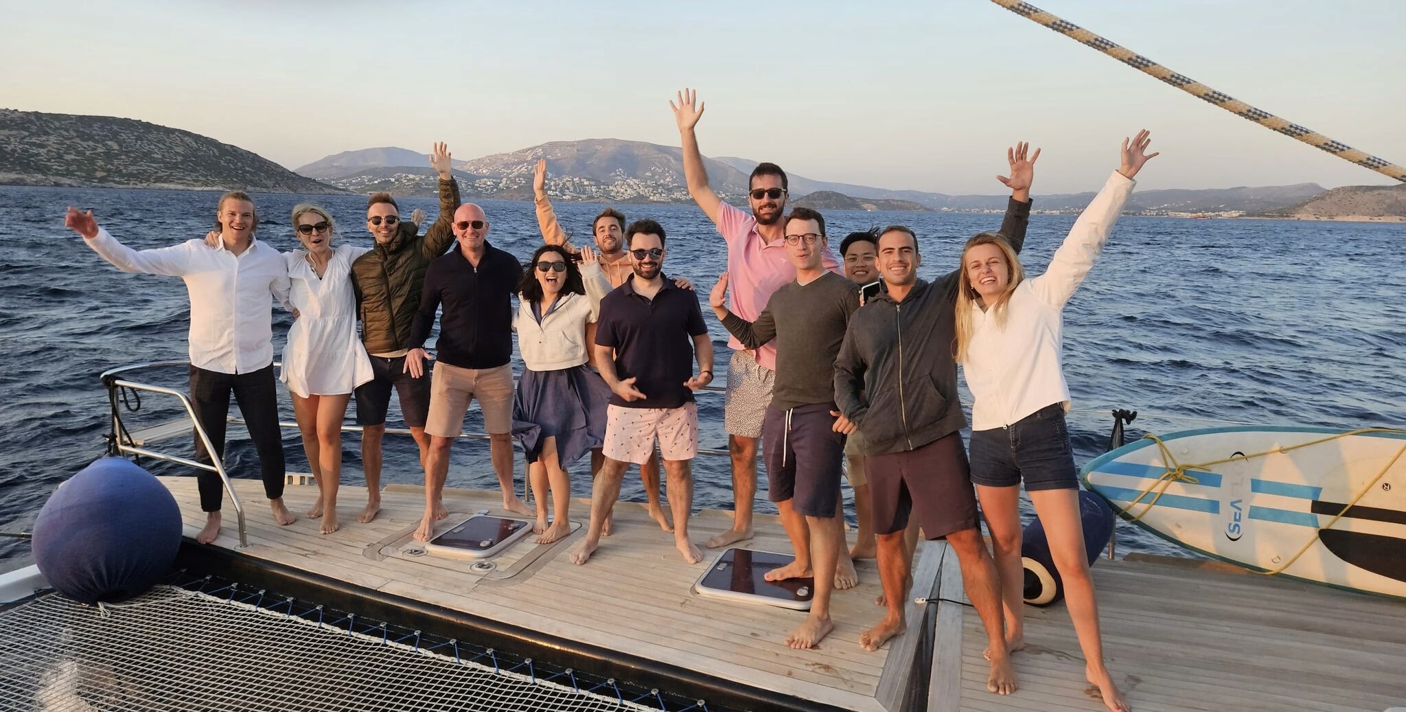 The VentureFriends group standing together on the deck of a boat