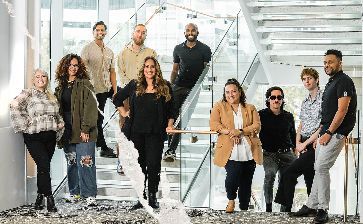 Members of the Vera Creative team gathered on a bright office staircase