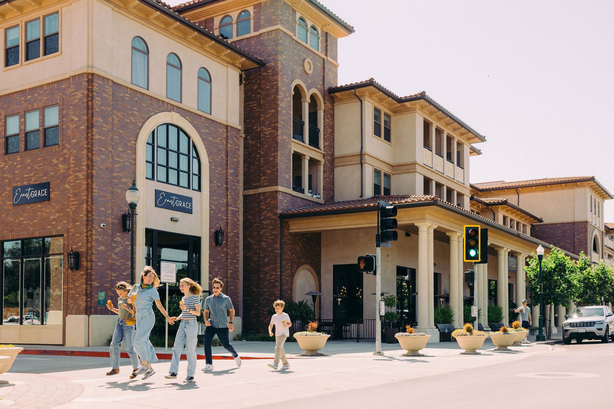 People carrying ice cream cross a sunny downtown Atascadero street in a campaign photograph