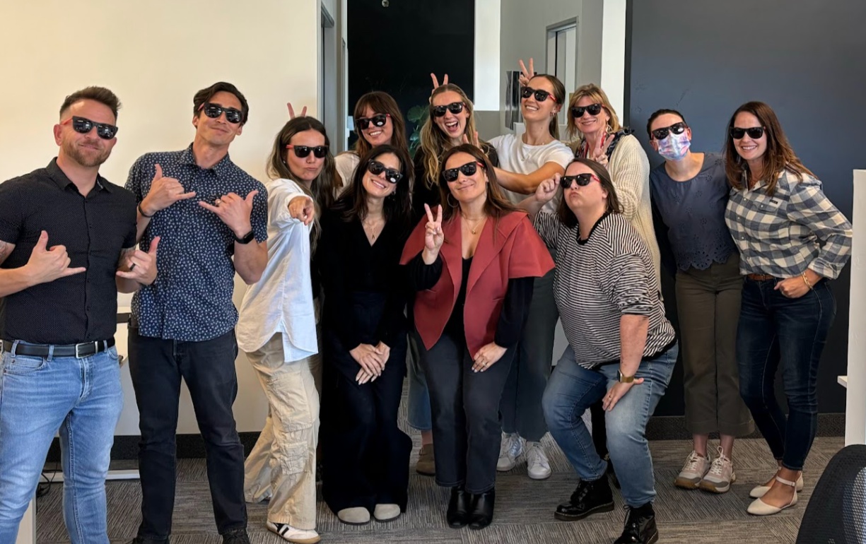 Verdin team members pose together wearing sunglasses in an office