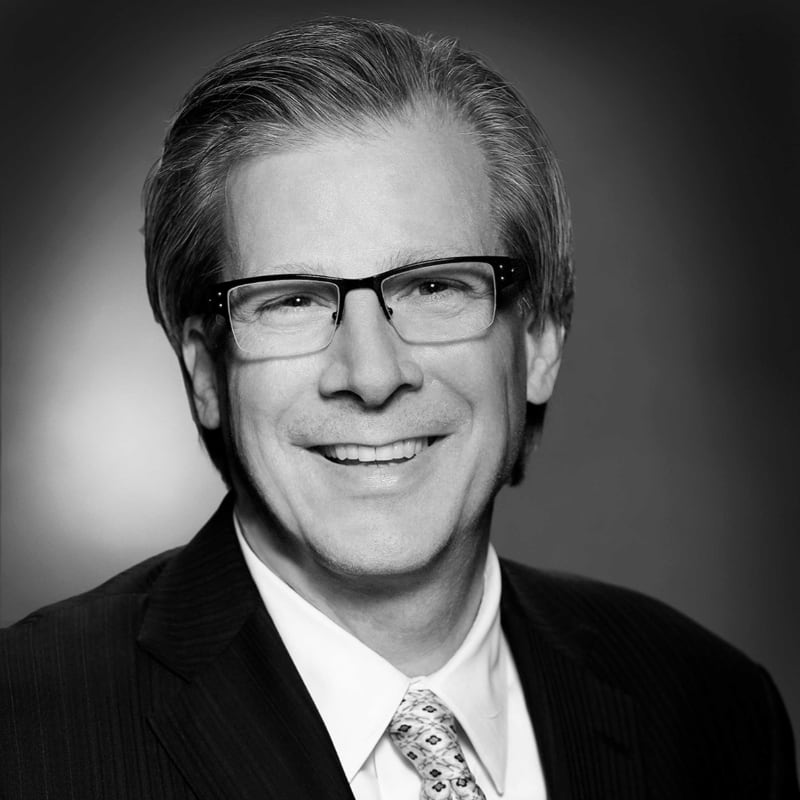 Black-and-white portrait of Verisys co-founder and chairman John P. Benson
