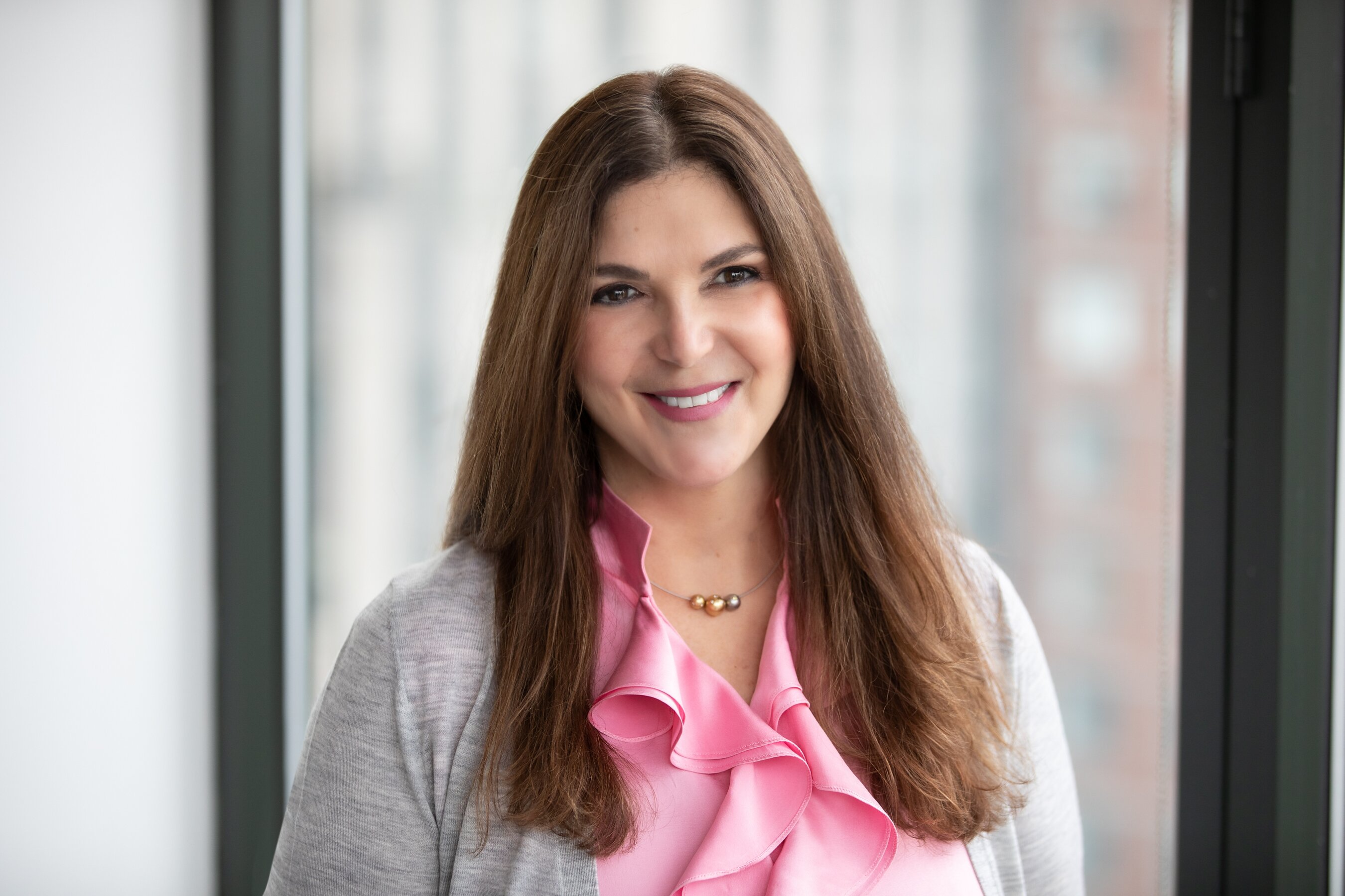 Cynthia E. Sachs, Versana’s founding CEO, in a gray jacket and pink blouse