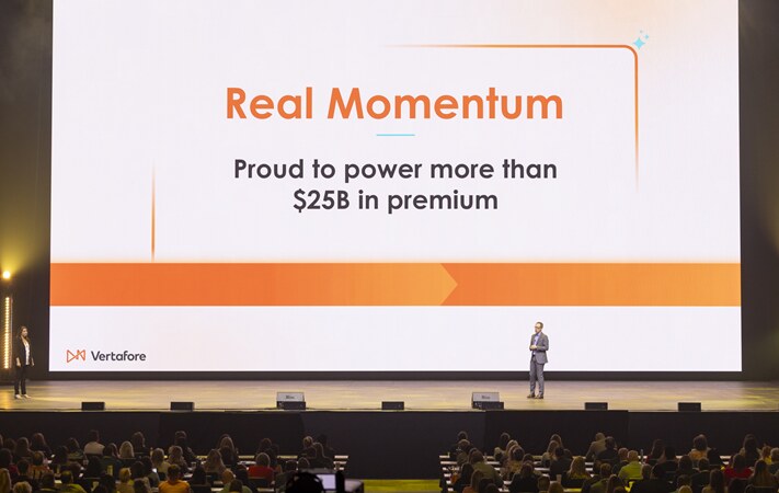 Vertafore executive presenting on a large conference stage at Accelerate 2026