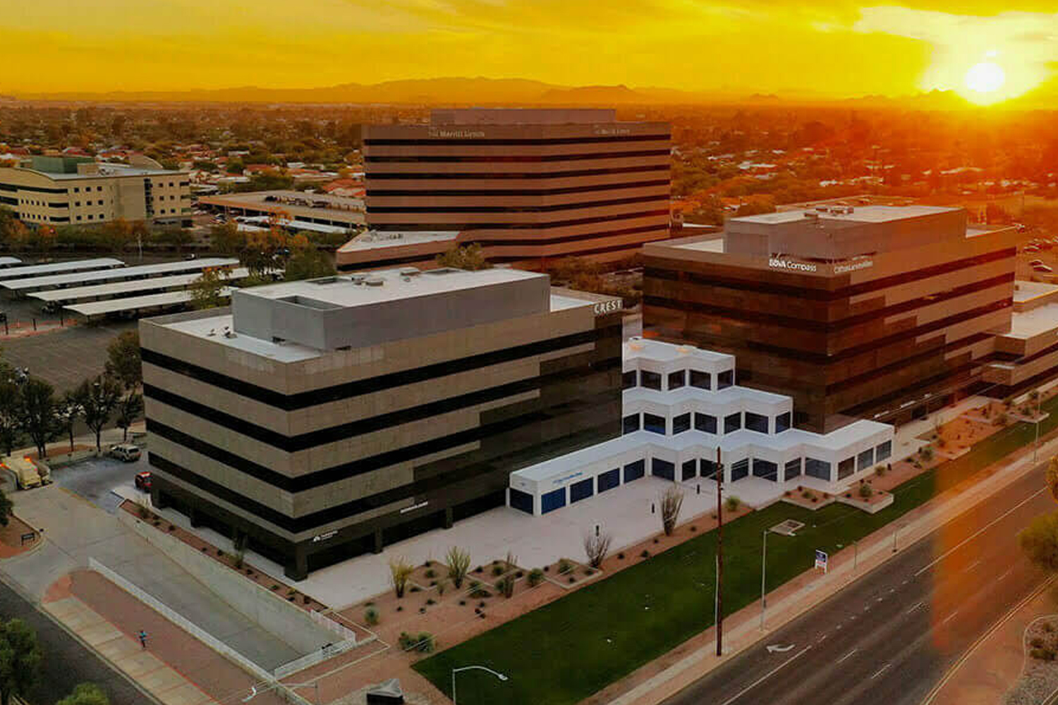 Crest-branded office building in a city at sunset