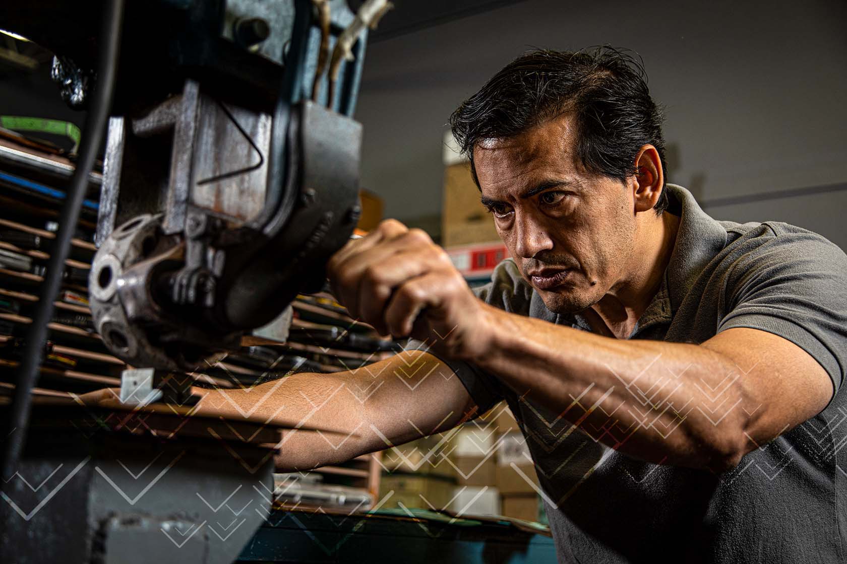 A factory worker concentrates on operating industrial machinery