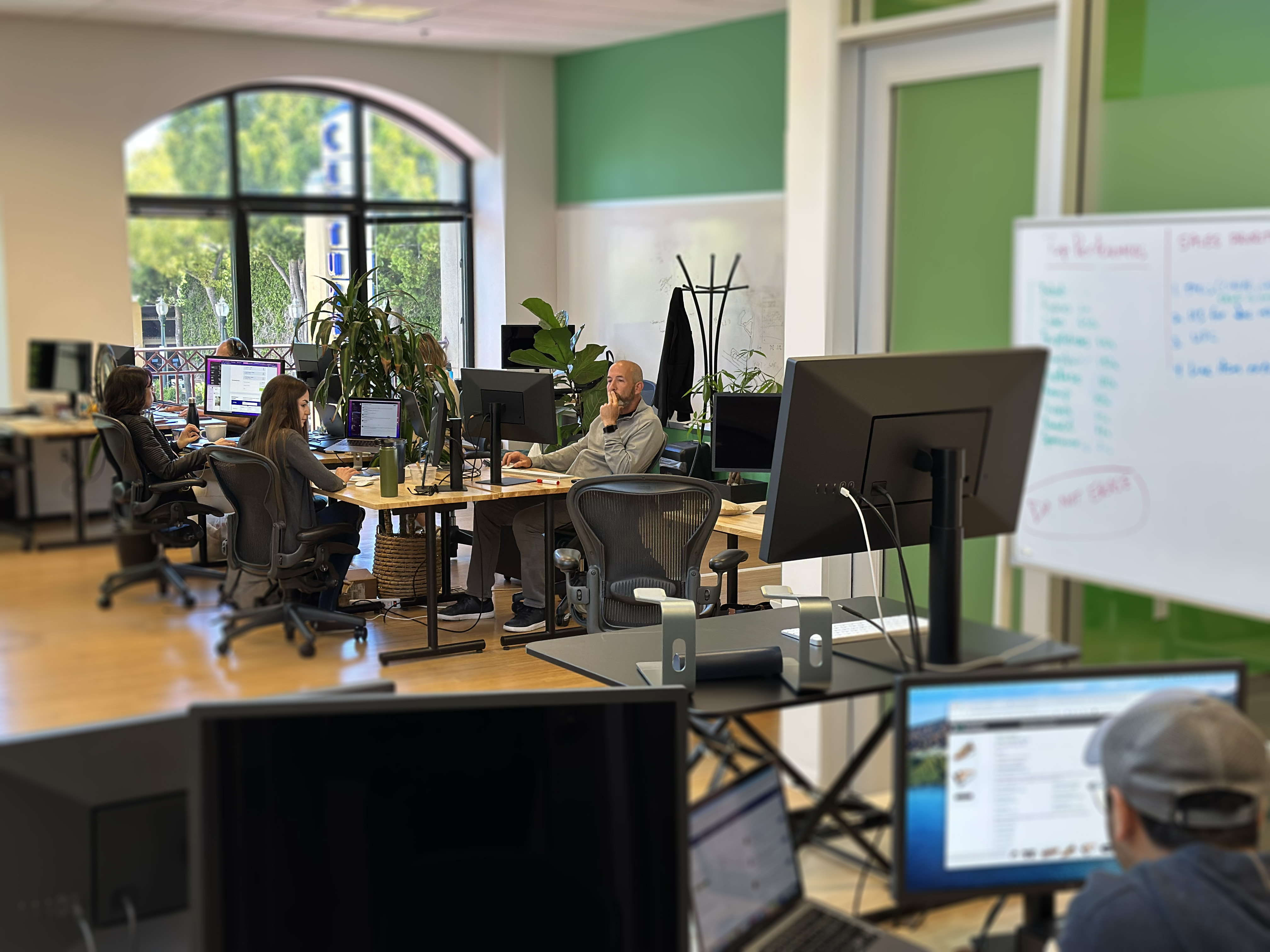 The Veryfi team gathered around a table at work