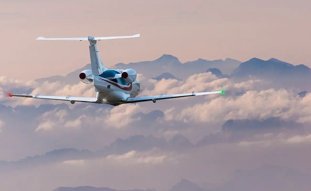 Business jet flying above clouds, from Veryon's Wing Aviation customer material