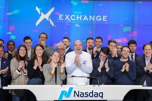A group pictured applauding at Nasdaq, in a photograph published by VettaFi