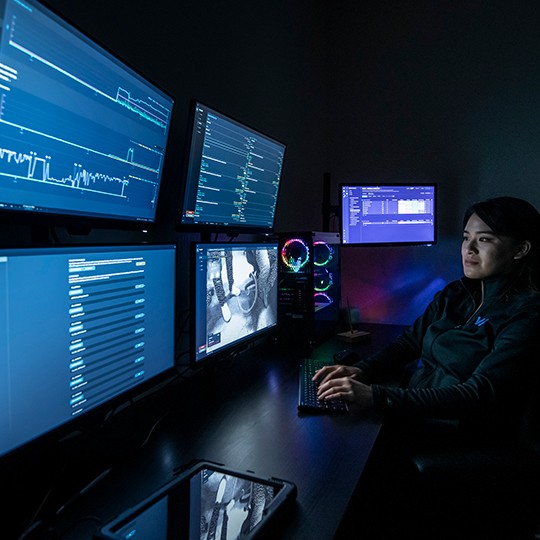 An operator monitors Viabot robot data on screens