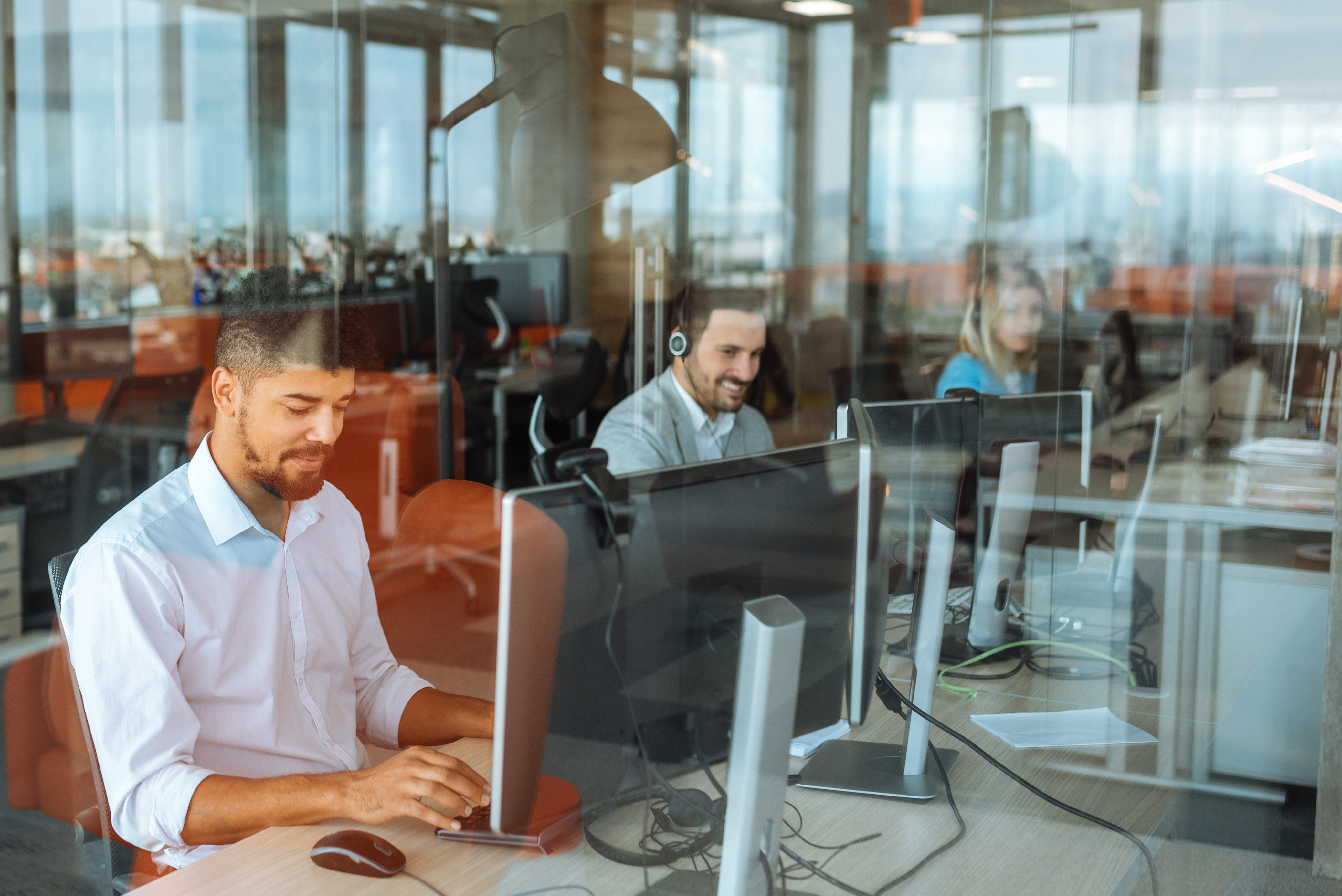 Illustrative customer-service agents at computers, from ViaPlus's service operations page
