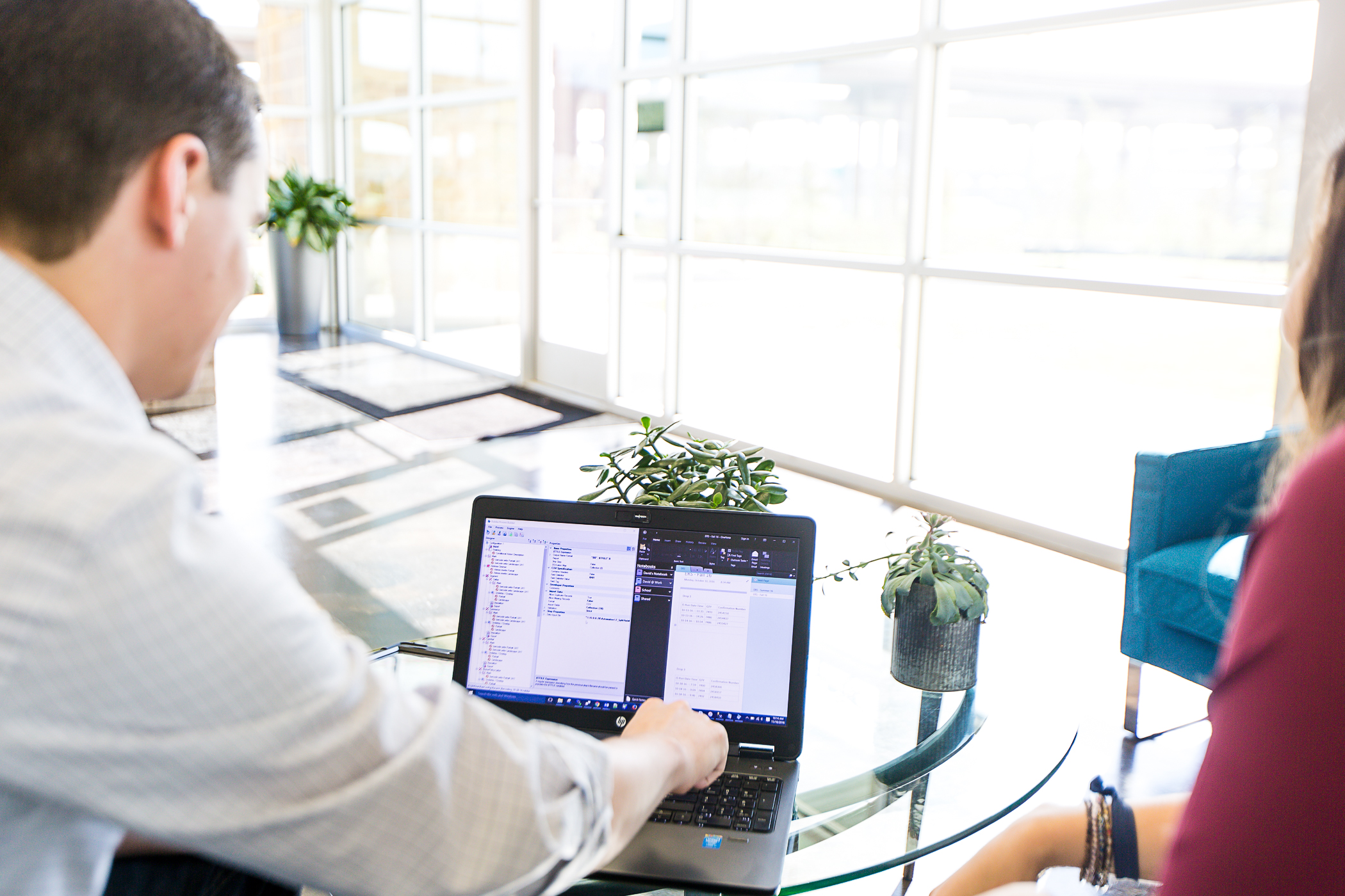 Two people working together at a laptop in a bright ViaTech office