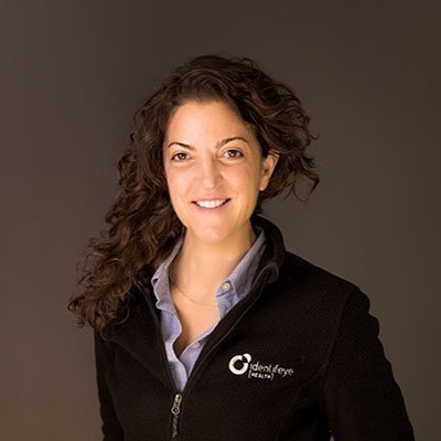 Vicky Demas in a black identifeye HEALTH jacket, in a portrait published with her Beyond the Binary interview