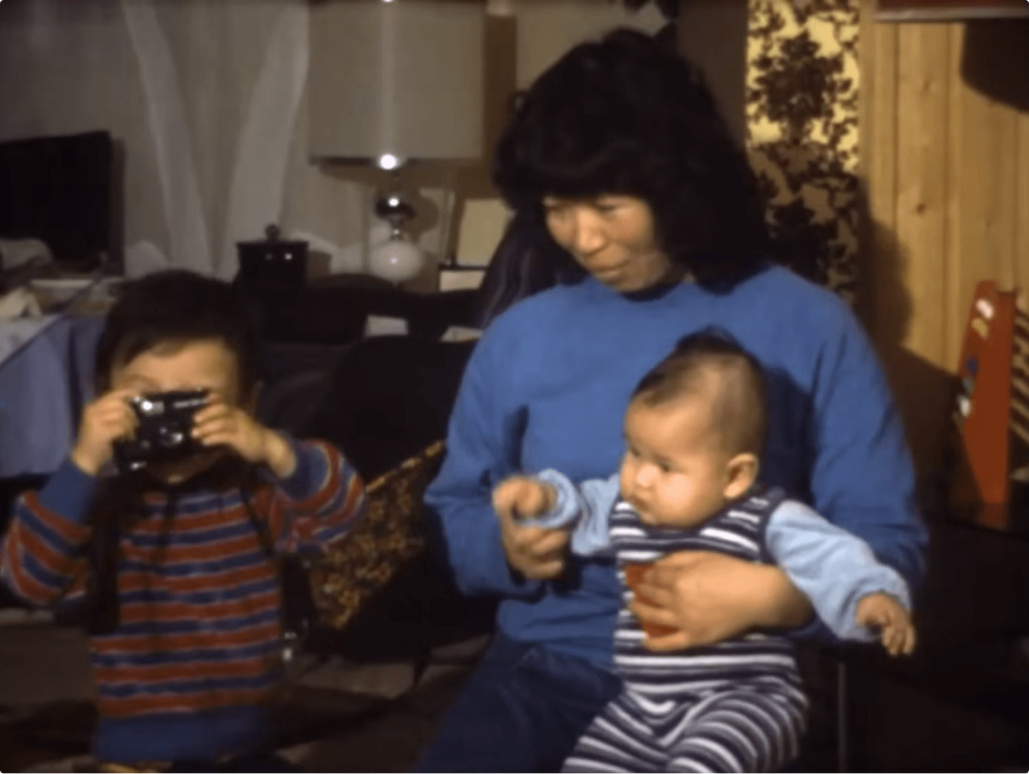 A young Victor Henning holds a compact camera in a family photograph
