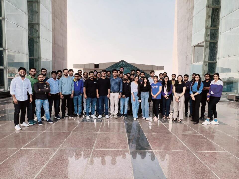 VideoVerse team gathered between two office buildings, in a photograph from the company’s careers page