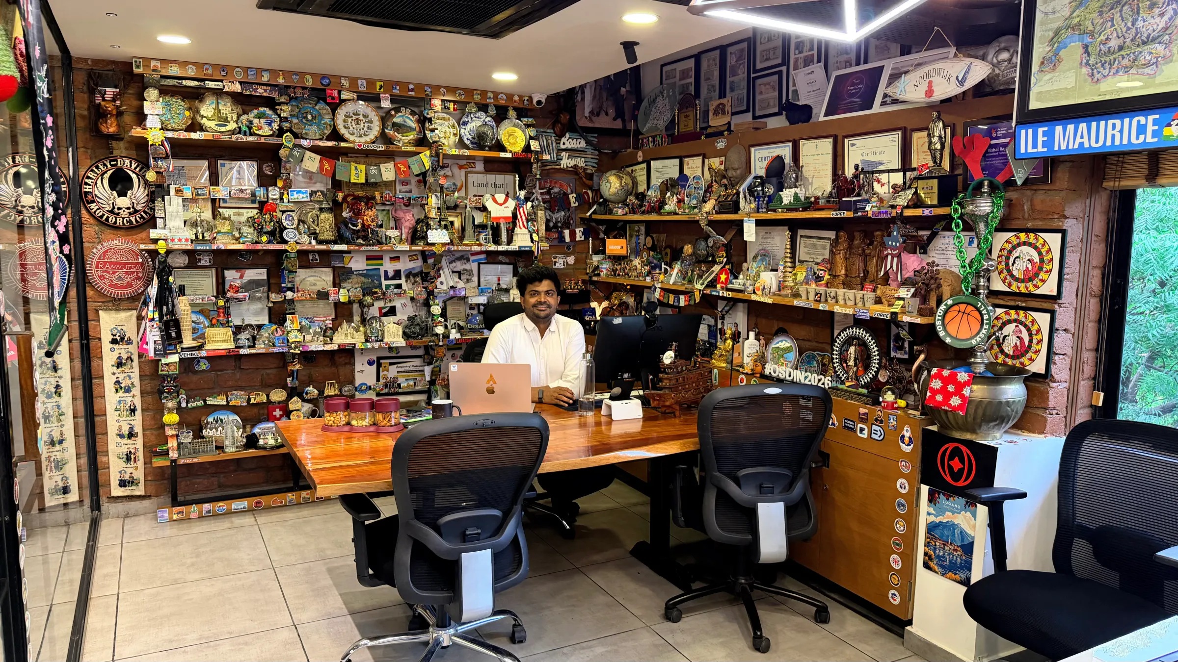 Vishal Rajpurohit’s desk surrounded by souvenirs, certificates and conference memorabilia