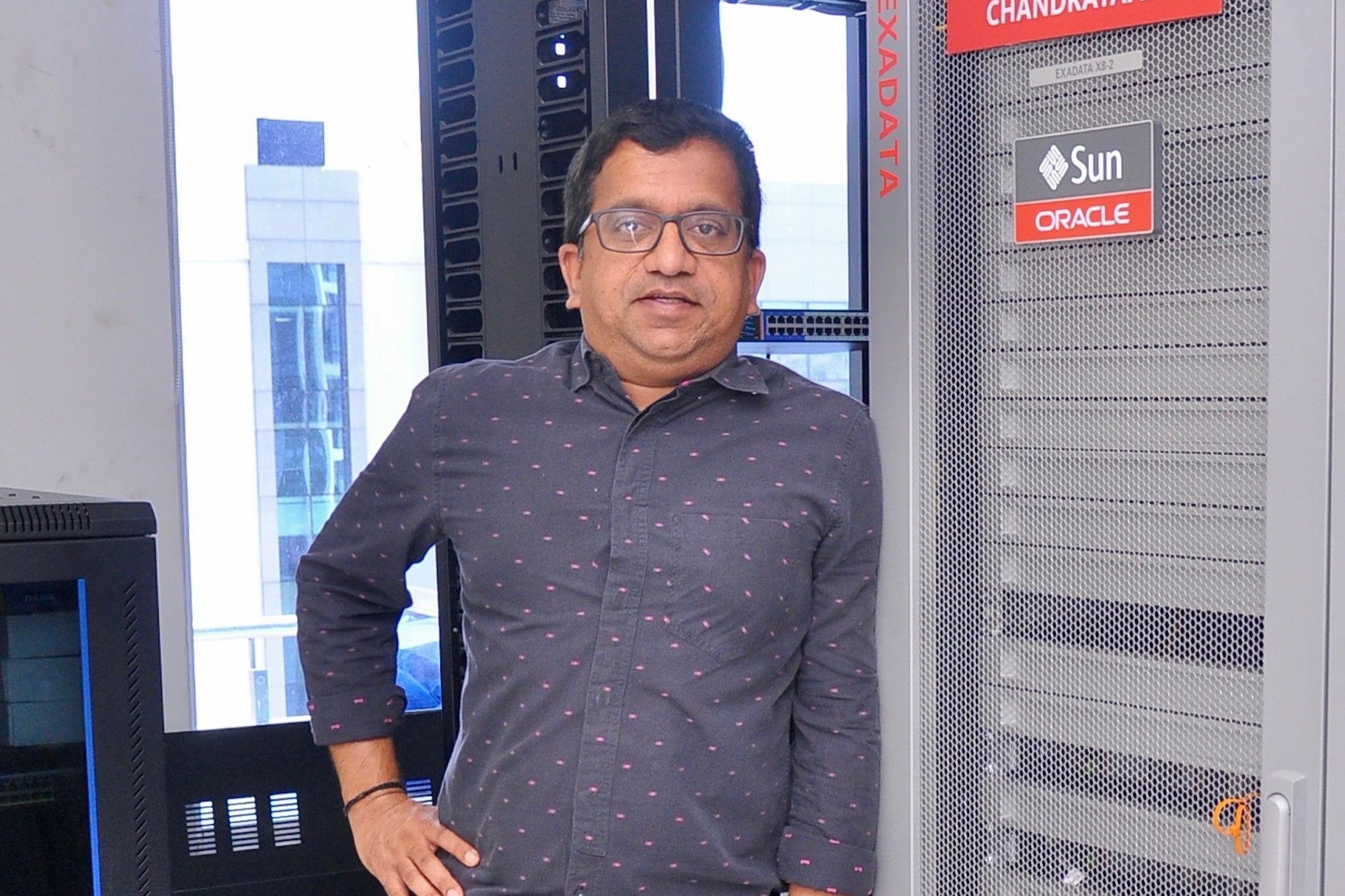 Vijay Cherukuri beside Oracle Exadata equipment