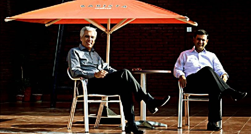 Vikram Talwar, left, and Rohit Kapoor seated outdoors beneath a Barista umbrella