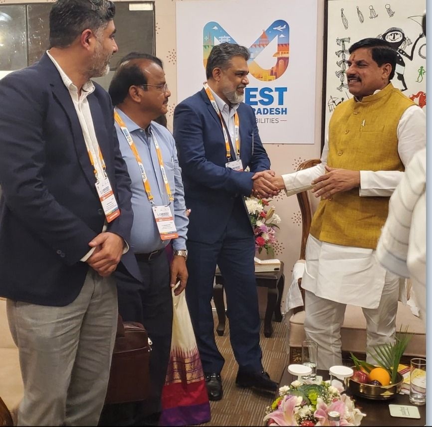 Vineet Dhawan shakes hands with Madhya Pradesh Chief Minister Mohan Yadav at Global Investors Summit 2025