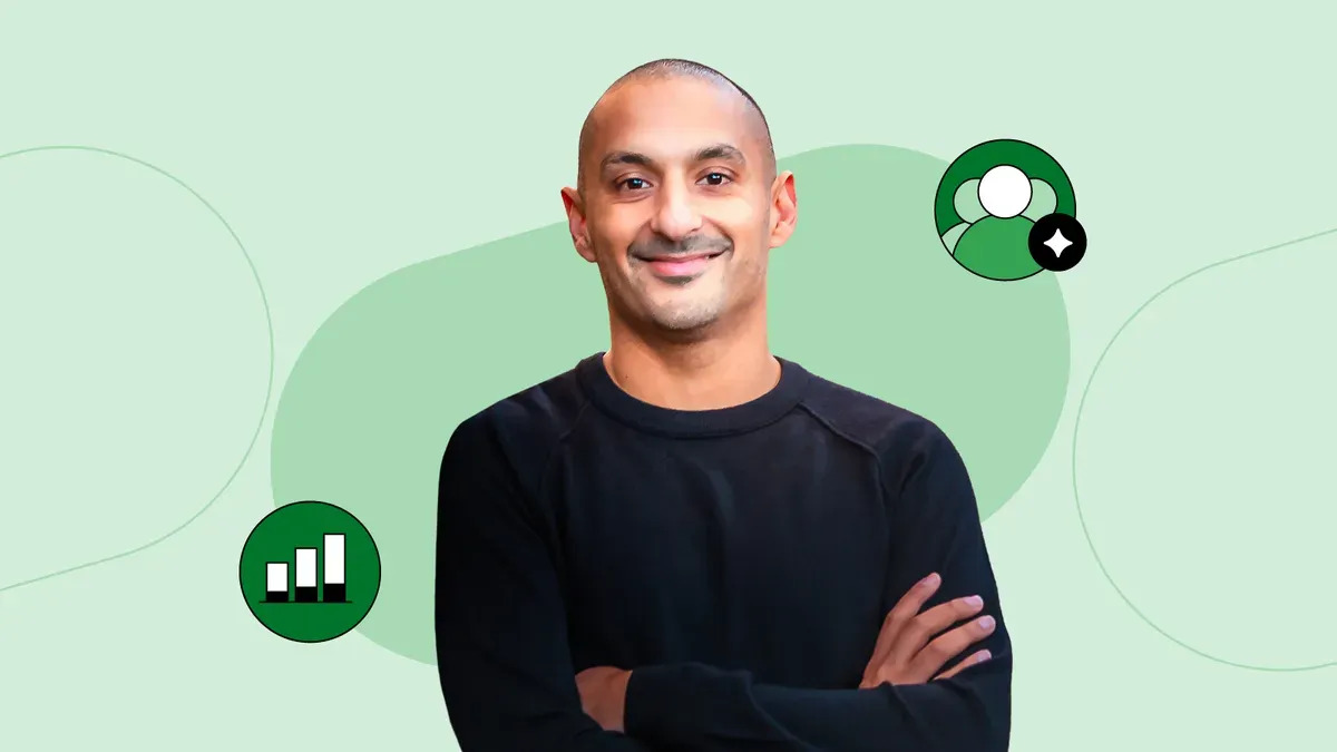 Vineet Mehra smiling with his arms crossed against a pale green illustrated background