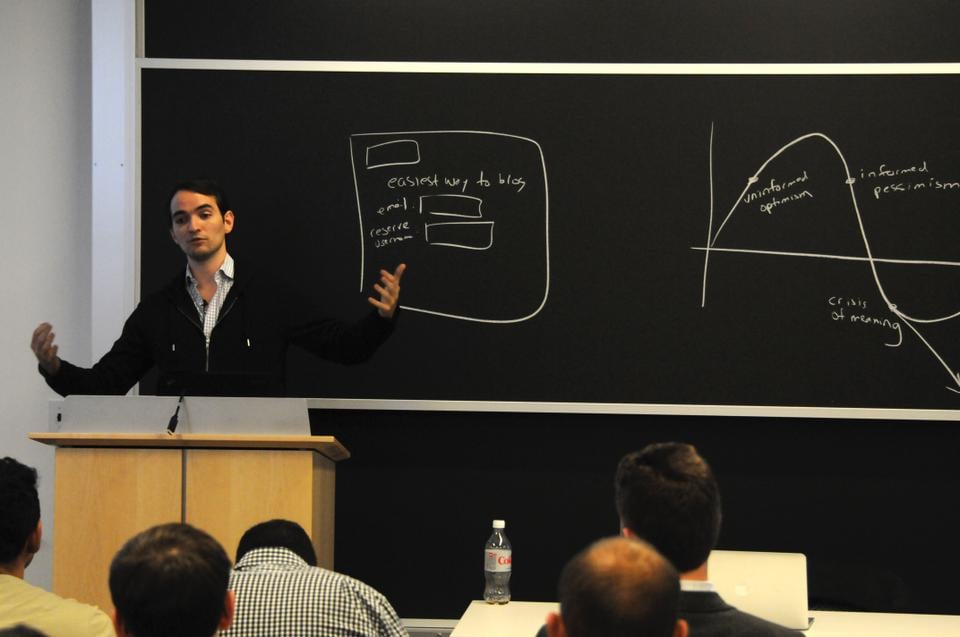 Vin Vacanti speaking beside a chalkboard at the Harvard Innovation Lab in 2011