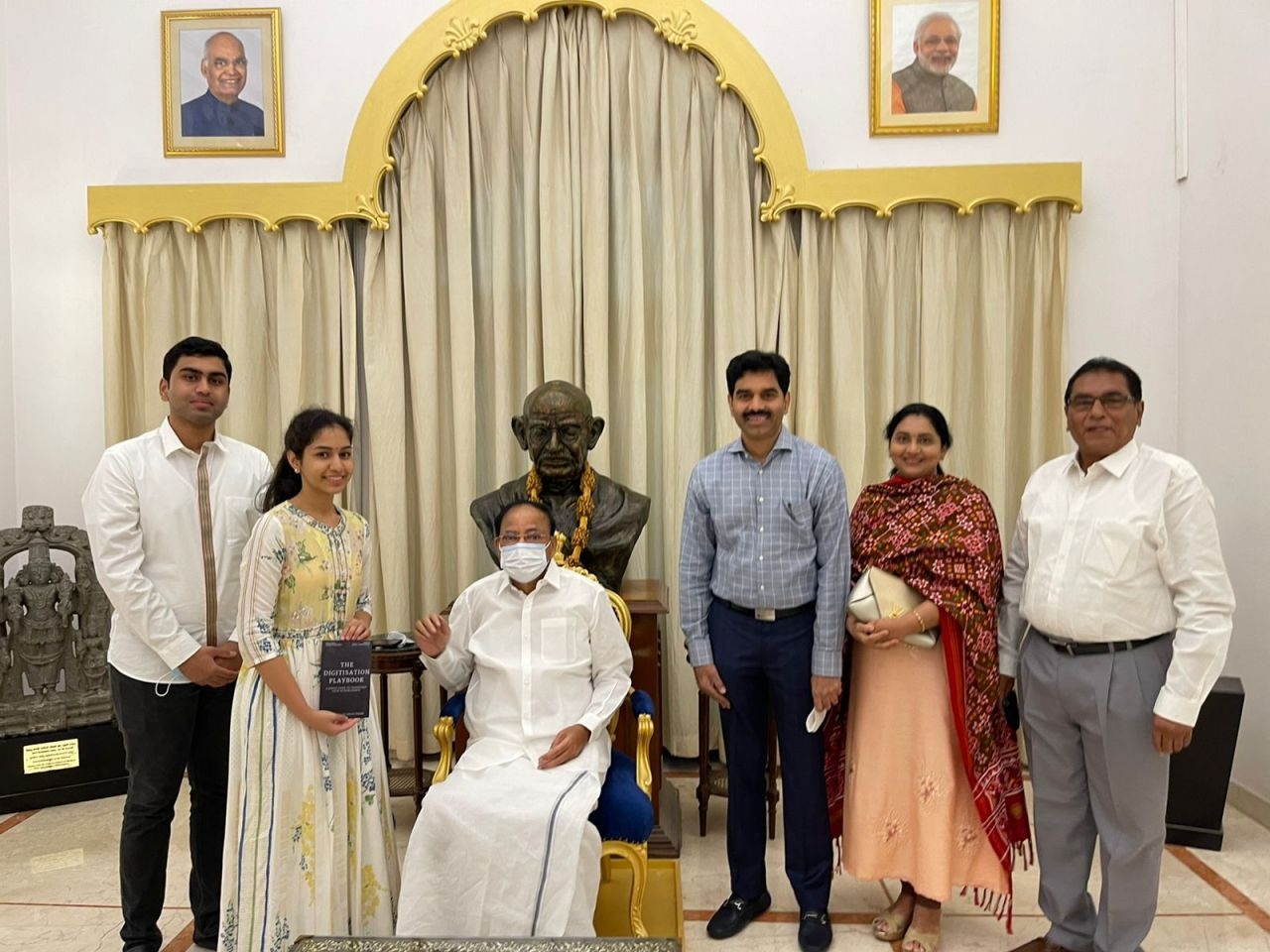 Vinod Reddy at a meeting with then Vice President Venkaiah Naidu, with Vinusha Narapareddy holding a book
