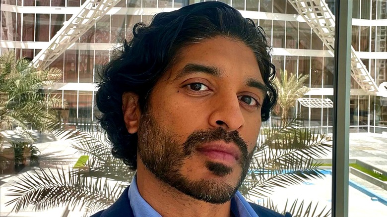 Vinoda Basnayake in a blue shirt, photographed beside a window