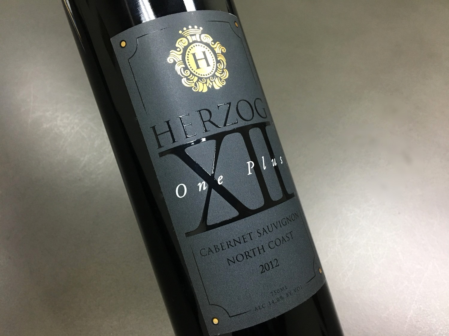 Herzog One Plus Cabernet Sauvignon bottle with a dark label, gold crest, and glossy lettering