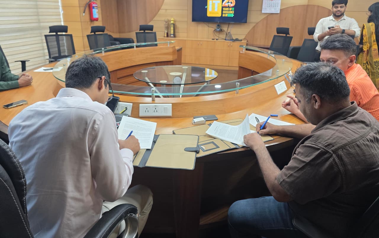 Vipin Vindal and Technopark CEO Sandip Kumar signing the campus memorandum at a conference table.
