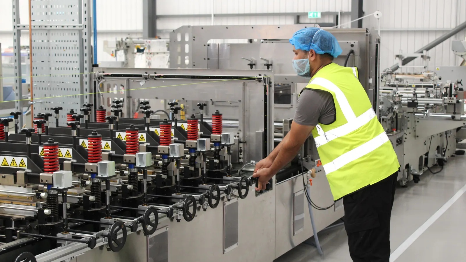 An ePac operator working at a pouch-making machine