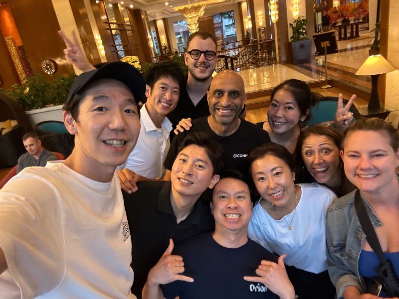 Viresh Chana in a black Connor shirt with smiling colleagues at the company's Chiang Mai gathering
