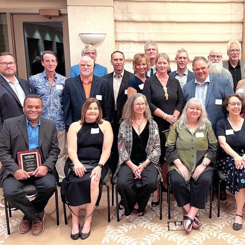 Virginia Devlin standing with fellow Northern Star alumni at a reunion gathering.