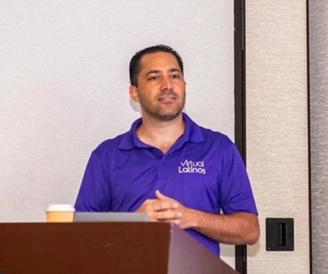 Virtual Latinos founder Jaime Nacach speaking at a lectern