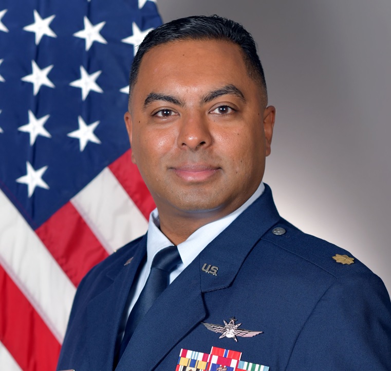 Vishaal Hariprasad in his U.S. Air Force uniform before an American flag