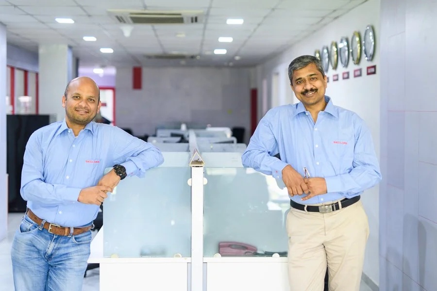 Vishal Gupta on the left and Abhijit Tannu on the right, standing in a Seclore office