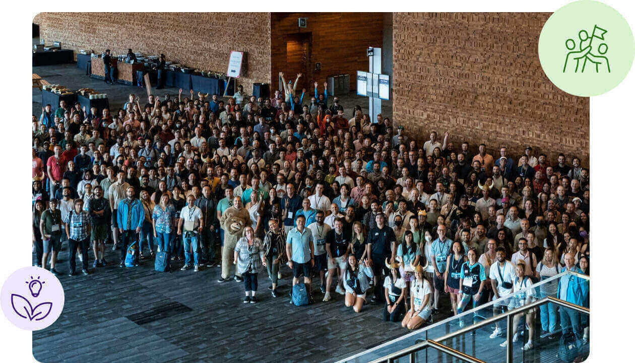 A large Visier company group gathered in a brick-walled event space