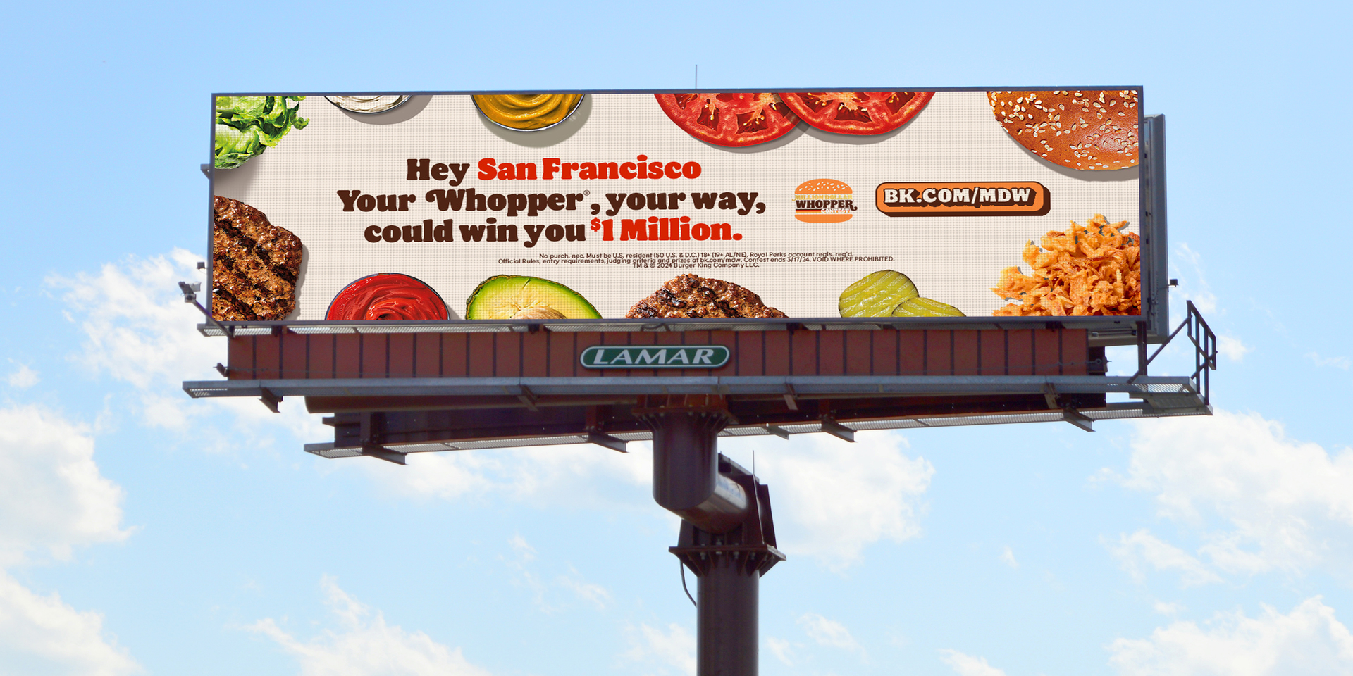 Burger King campaign on a large Lamar digital billboard beneath a blue sky