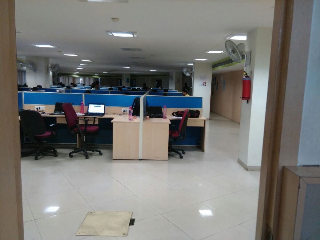 Rows of desks and blue dividers in the InnoEye office pictured in an engineer’s 2015 blog post
