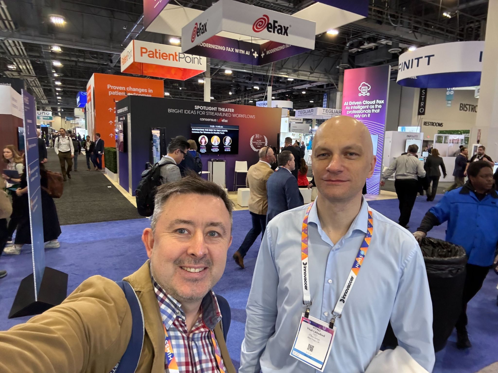 Vitali Likhadzed, right, and colleague Dzmitry Krotau on a conference exhibition floor.