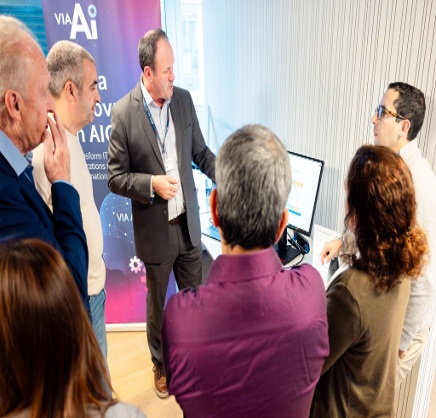 A small group gathers around a Vitria demonstration at a Tomorrow Street event in Luxembourg