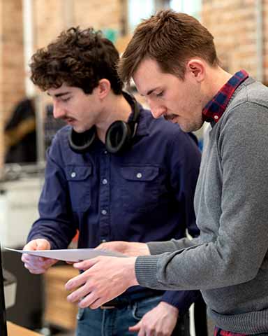 Two members of the Vitu Illinois team reviewing a document together