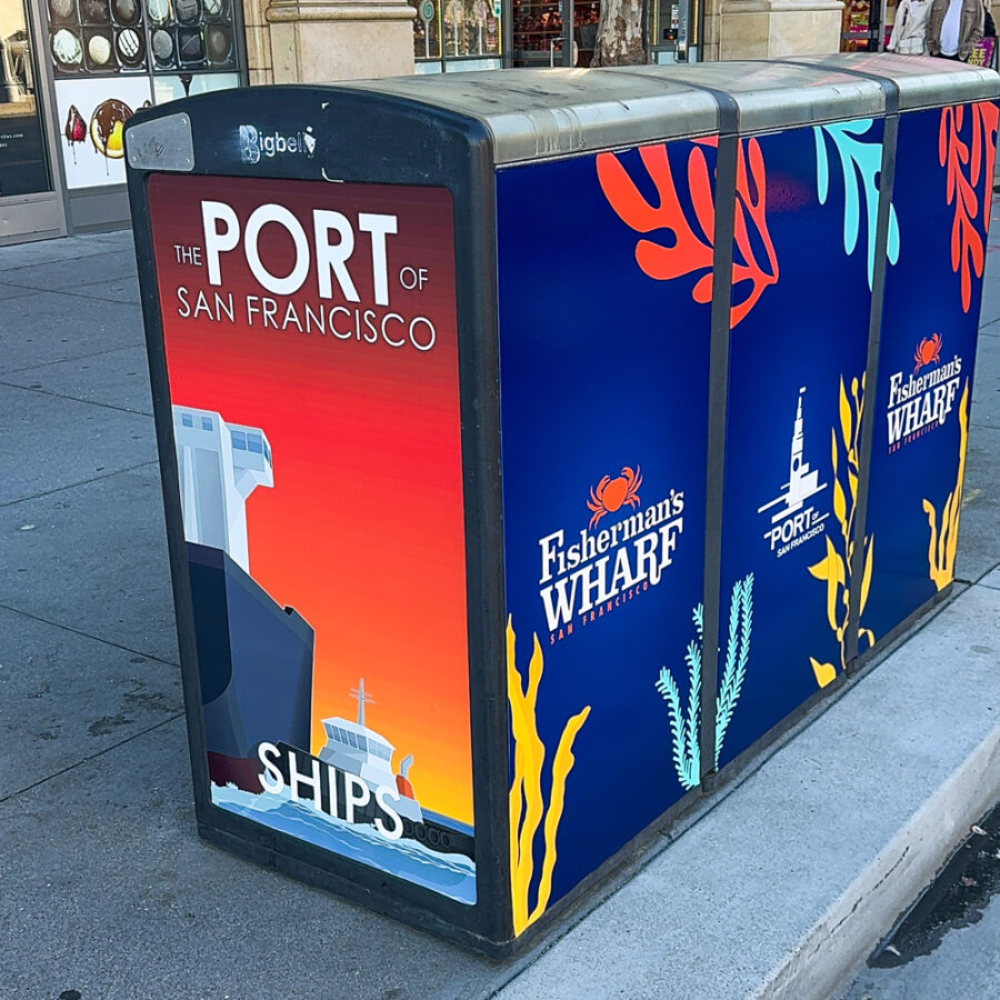 A public recycling unit wrapped with colorful Fisherman's Wharf graphics
