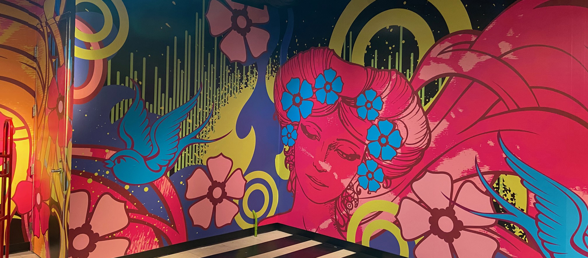 Large colorful VIVAS graphics installed on a San Francisco building facade