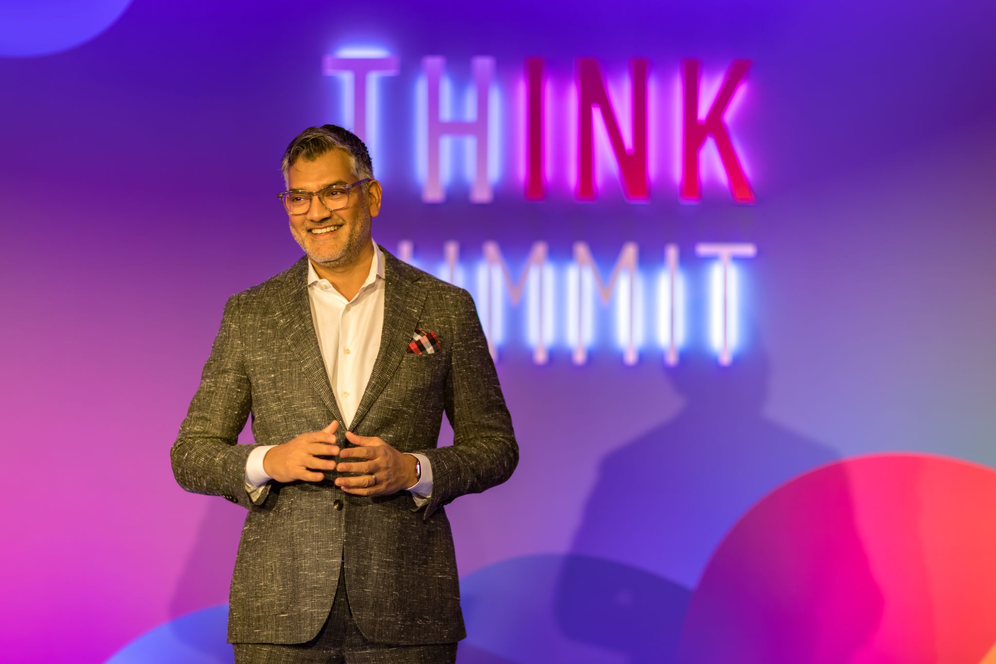 Vivek Sharma smiling onstage at Think Summit Europe in 2025